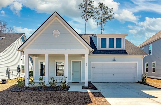 view of front of property featuring a porch, concrete driveway, a shingled roof, and a garage