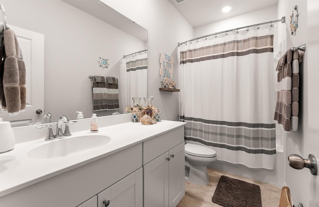 bathroom featuring toilet, curtained shower, and vanity