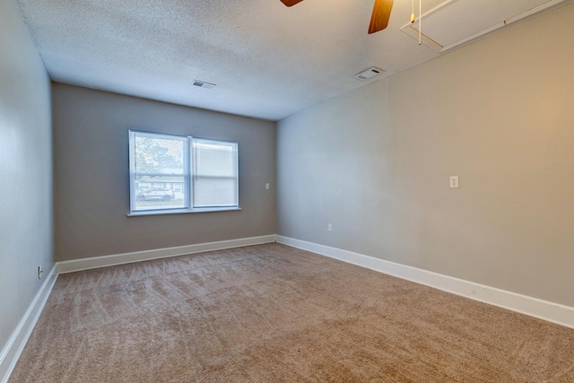 unfurnished room with a textured ceiling and carpet floors