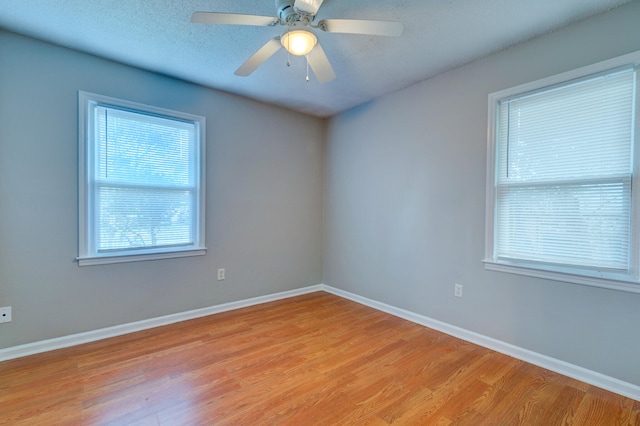 spare room with ceiling fan, a textured ceiling, and light hardwood / wood-style flooring