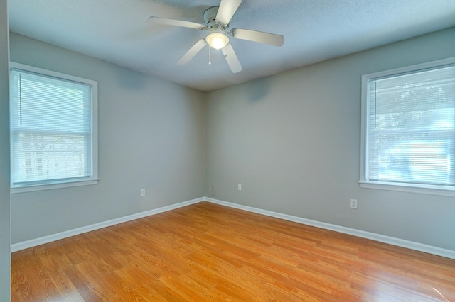 empty room featuring ceiling fan and light hardwood / wood-style floors