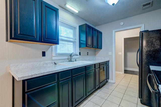 kitchen featuring wine cooler, a textured ceiling, light tile patterned floors, black refrigerator, and sink