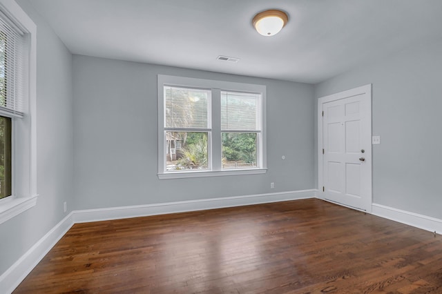unfurnished room featuring wood finished floors and baseboards