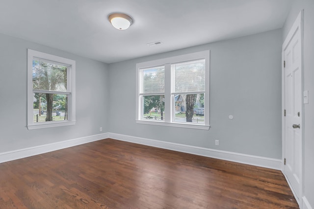 unfurnished bedroom with dark wood finished floors and baseboards