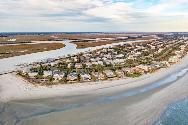 drone / aerial view featuring a beach view and a water view