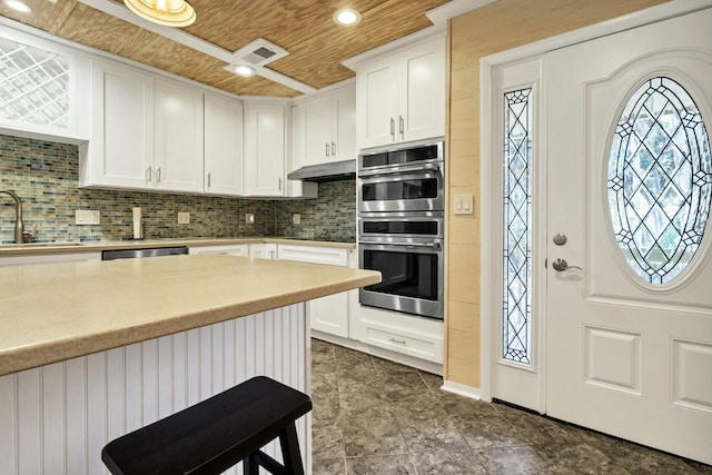 818 Club Cottage Ct, Edisto Beach, SC 29438 - kitchen featuring a sink, wooden ceiling, under cabinet range hood, white cabinetry, and tasteful backsplash
