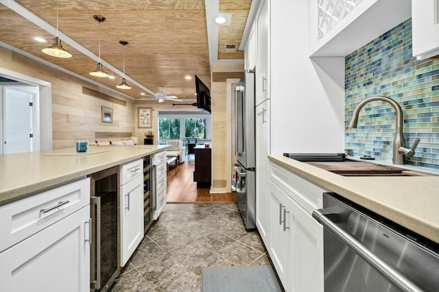 818 Club Cottage Ct, Edisto Beach, SC 29438 - kitchen featuring appliances with stainless steel finishes, a sink, beverage cooler, wood ceiling, and wooden walls