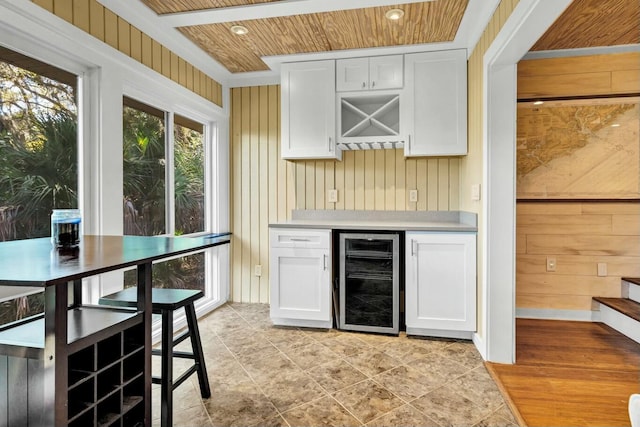 818 Club Cottage Ct, Edisto Beach, SC 29438 - indoor dry bar featuring beverage cooler, stairway, wood walls, and wood ceiling