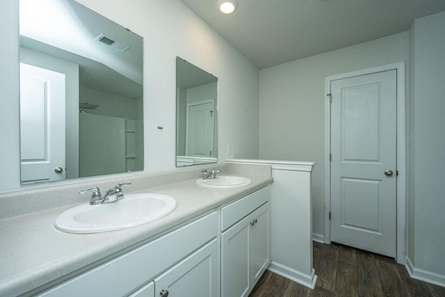 bathroom with hardwood / wood-style floors and vanity