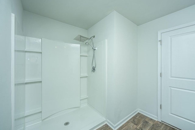 bathroom featuring hardwood / wood-style flooring and a shower