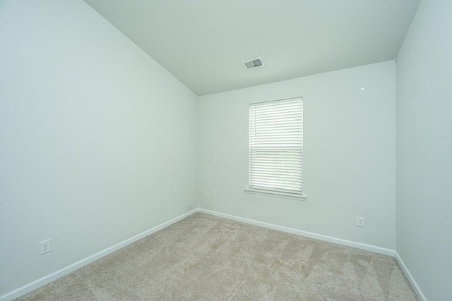 empty room featuring light carpet