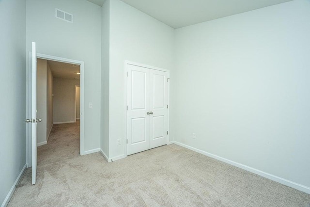 unfurnished bedroom with light carpet