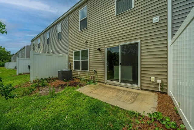 back of house featuring a patio, a lawn, and central air condition unit