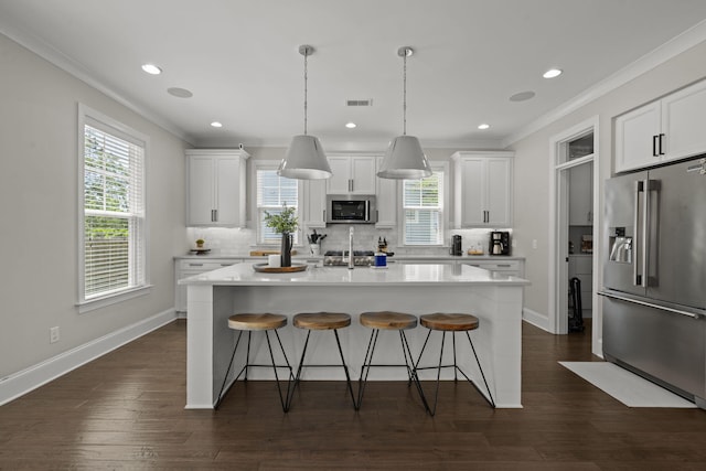 4019 Cascades Thrust, Summerville, SC 29483 - kitchen featuring stainless steel appliances, tasteful backsplash, visible vents, crown molding, and a kitchen bar