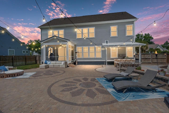 4019 Cascades Thrust, Summerville, SC 29483 - back of house at dusk featuring a fenced backyard, a sunroom, and a patio area
