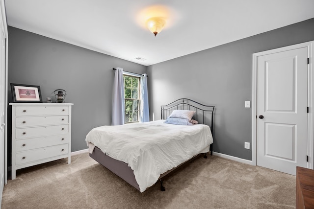 carpeted bedroom with baseboards and visible vents