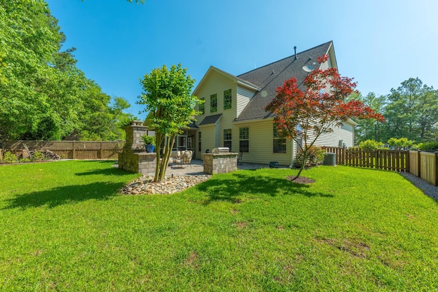 rear view of property with roof with shingles, a fenced backyard, a patio area, central air condition unit, and a lawn