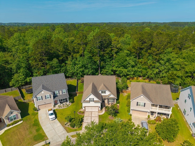 drone / aerial view with a view of trees and a residential view