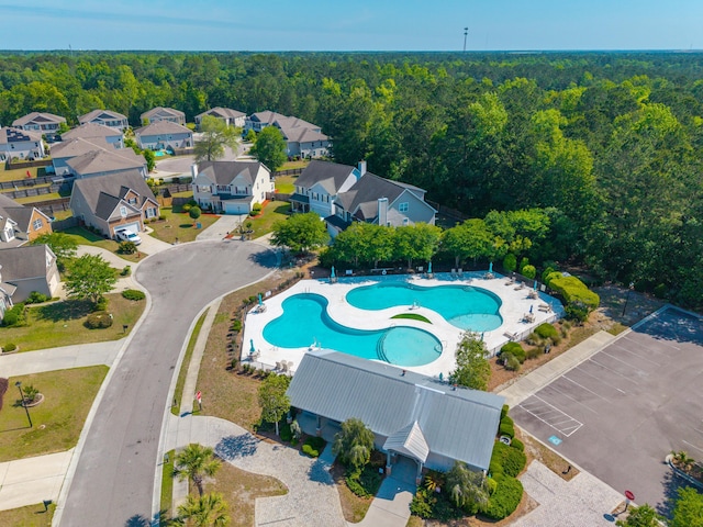 birds eye view of property featuring a wooded view