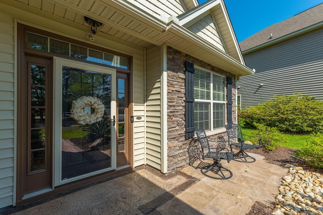 doorway to property featuring stone siding