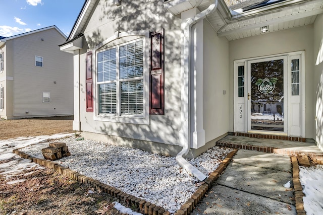 view of snow covered property entrance