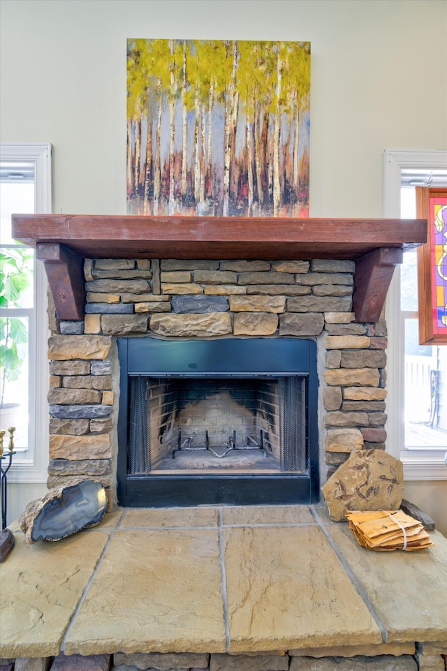 interior details featuring a stone fireplace