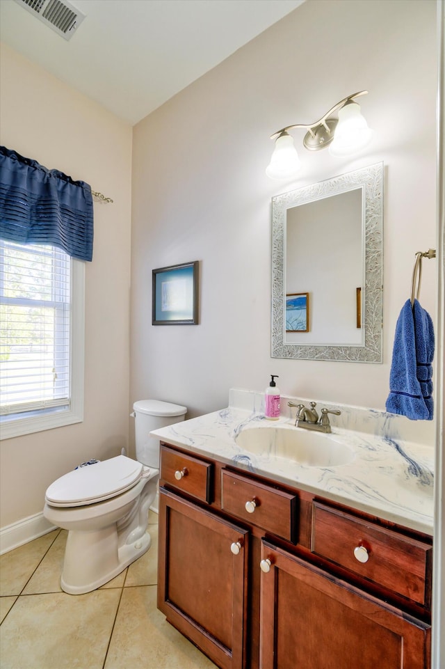 bathroom with vanity, toilet, baseboards, tile patterned floors, and visible vents