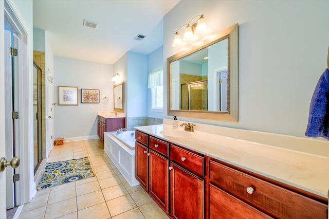 bathroom featuring tile patterned floors, a stall shower, a garden tub, and visible vents