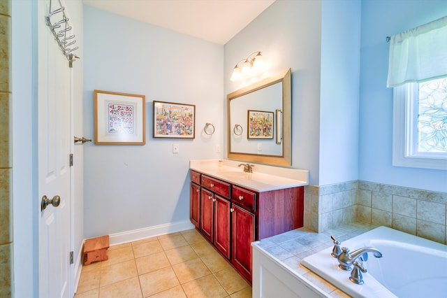 bathroom with a bath, baseboards, tile patterned floors, and vanity
