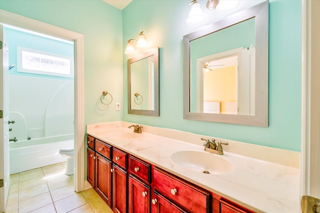 bathroom featuring double vanity, a sink, tile patterned floors, and toilet