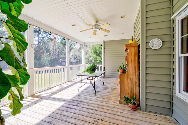 wooden terrace with a ceiling fan