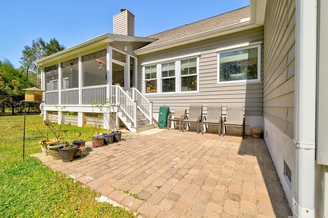 view of patio / terrace featuring a sunroom