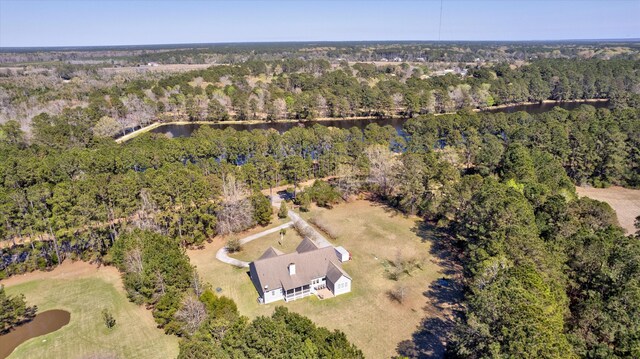 birds eye view of property featuring a wooded view and a water view