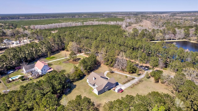 drone / aerial view featuring a water view and a view of trees