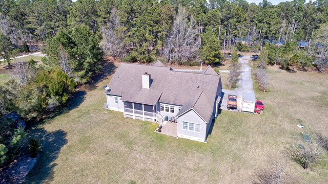 drone / aerial view featuring a wooded view