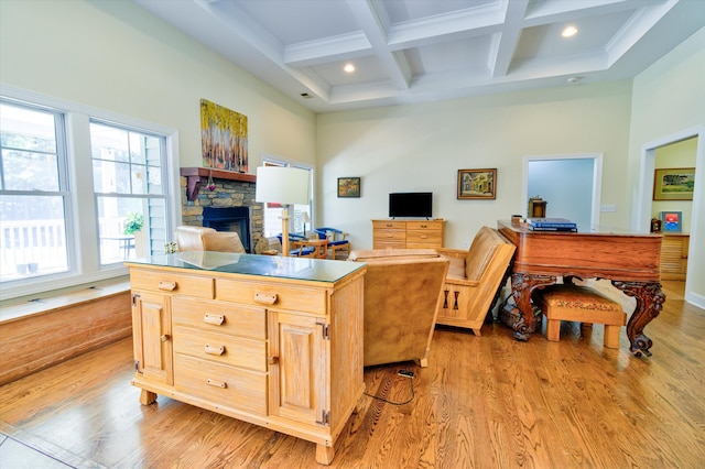office area featuring coffered ceiling, a towering ceiling, beam ceiling, light wood-style flooring, and a fireplace
