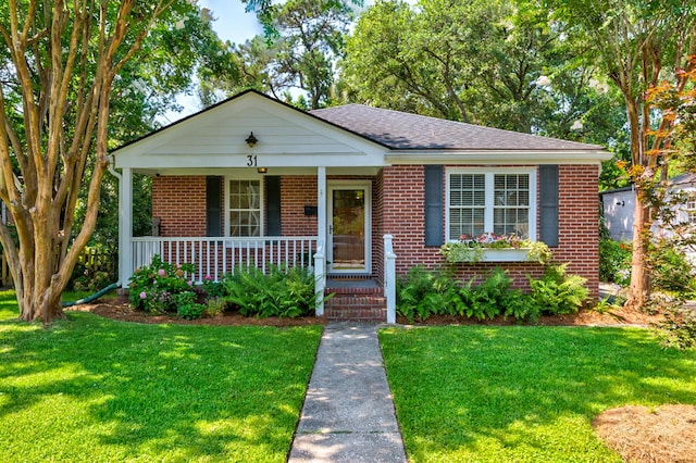 31 Lyttleton Ave, Charleston, SC 29407 - bungalow-style home with brick siding, a front yard, a porch, and a shingled roof