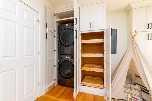 31 Lyttleton Ave, Charleston, SC 29407 - washroom featuring stacked washer and clothes dryer, light wood-style flooring, and electric panel