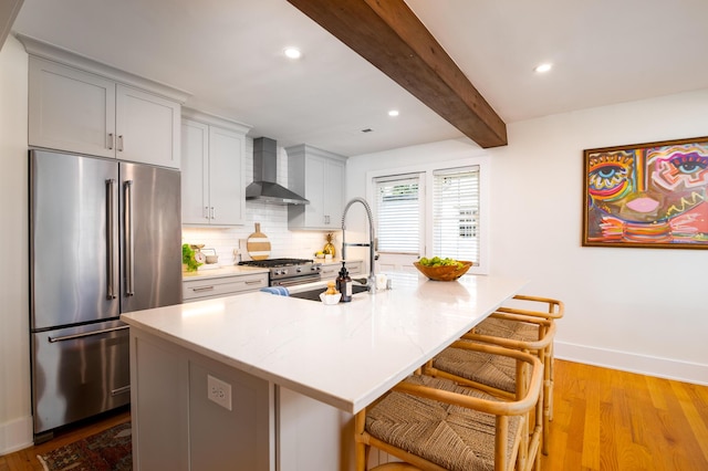 31 Lyttleton Ave, Charleston, SC 29407 - kitchen with high quality appliances, wall chimney range hood, beam ceiling, tasteful backsplash, and a breakfast bar