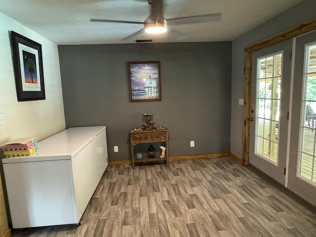 laundry area featuring light wood finished floors, visible vents, baseboards, and ceiling fan