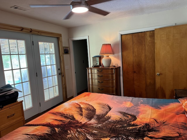 bedroom with visible vents, a textured ceiling, and ceiling fan