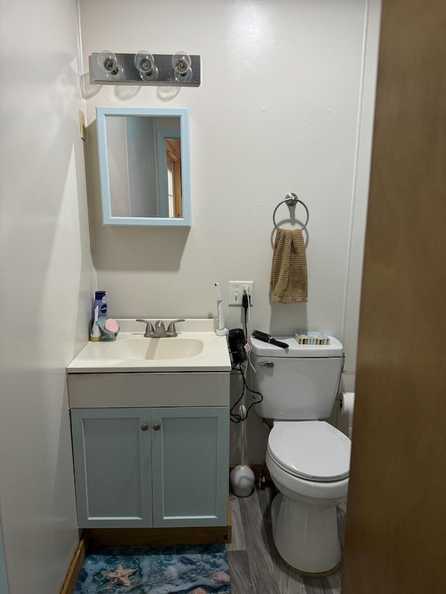 half bath featuring toilet and vanity