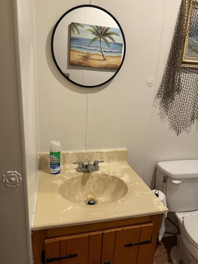 half bath featuring toilet and vanity