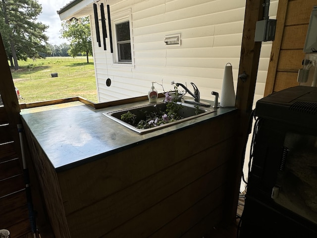 exterior space with dark countertops, washer / clothes dryer, and a sink