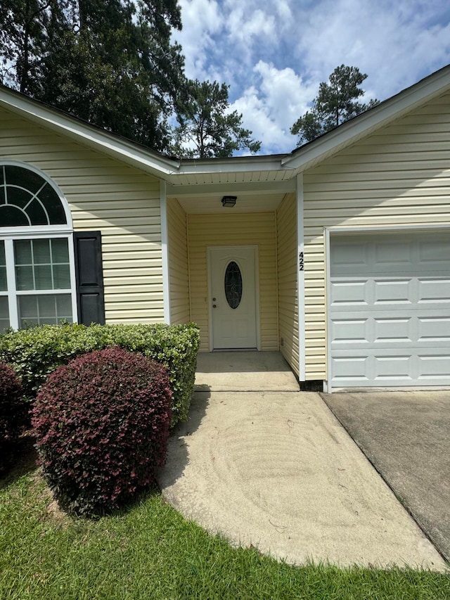 view of exterior entry with a garage