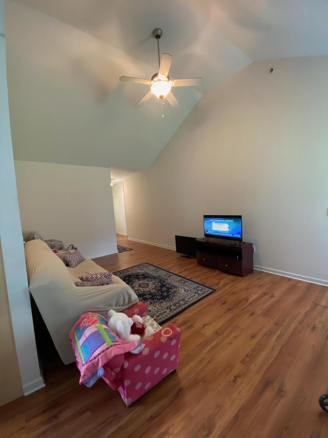 living room featuring high vaulted ceiling, baseboards, a ceiling fan, and wood finished floors