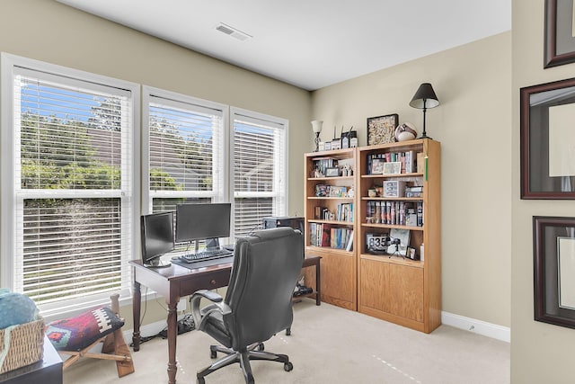 office with baseboards, plenty of natural light, carpet flooring, and visible vents