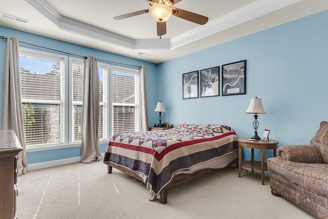 bedroom with visible vents, crown molding, baseboards, carpet, and a tray ceiling