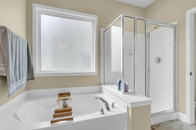 full bath featuring a bath and a stall shower