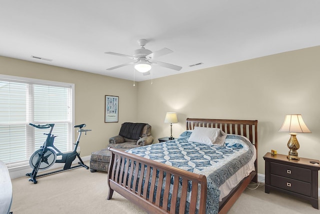 bedroom featuring baseboards, visible vents, and light colored carpet